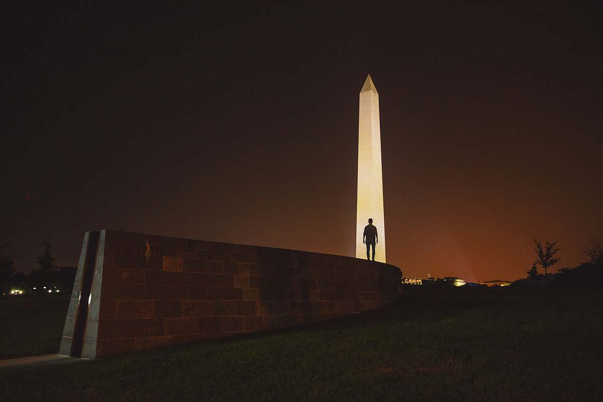 united states man standing on front of Obelisk in Egypt monument